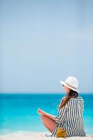 Young fashion woman in green dress on the beach photo