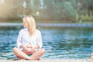 Pregnant woman in outdoor park, warm weather photo