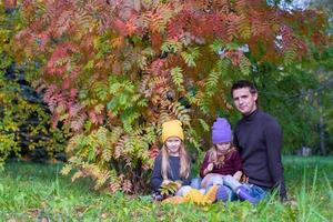 Happy family in autumn park outdoors photo