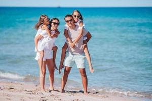 Happy family on the beach during summer vacation photo