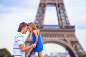 Happy family in Paris near Eiffel Tower during summer french vacation photo