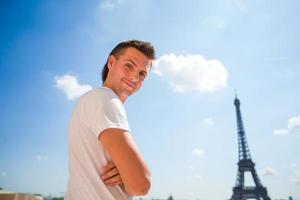 Happy man in Paris background the Eiffel tower photo