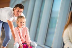 Happy family in airport have fun waiting for boarding photo