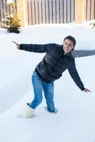 Young man in winter boots fell into a deep white snow photo