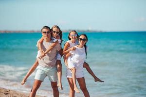 Happy family on the beach during summer vacation photo