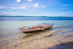 Small fishing boat in turquoise lagoon photo