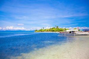 Small boats on the white tropical beach photo