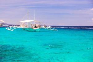 Big catamaran in turquoise open sea near Bohol island photo