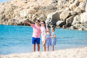 Young beautiful family on the beach photo
