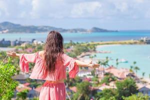 Young tourist woman with view of bay at tropical island in the Caribbean Sea photo