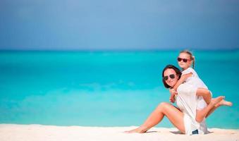 Mother and daughter enjoying time together at tropical beach photo