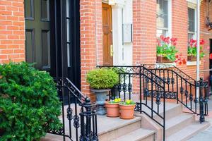 Old houses with stairs in the historic district of West Village photo