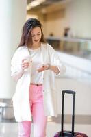 caucasian tourist young woman an airport waiting for her aircraft photo