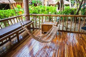 Hammock on terrace of cozy room in hotel in summer day photo