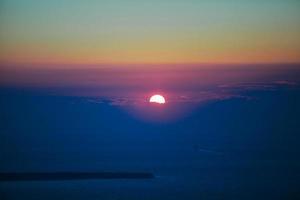 Famous sunset above Caldera view over sea in Santorini Island photo