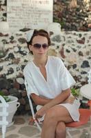 Young woman having breakfast at resort restaurant in Greece photo