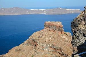 Skaros rock in Santorini against blue sea as a background photo