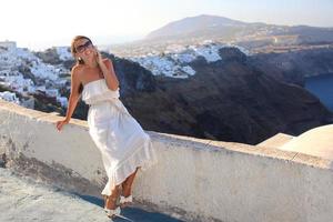 Beautiful young woman talking on phone, Greece photo