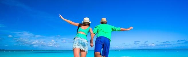 Young happy couple during tropical beach vacation photo