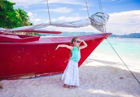 Beautiful little girl having fun on an exotic beach photo