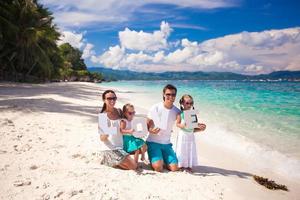 Young family and two kids with word LOVE on tropical vacation photo