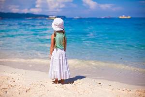 Adorable little girl walking on tropical beach in Boracay island, Philippines photo