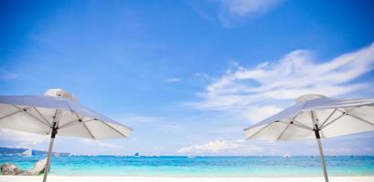 White umbrella at beach background the blue sea photo