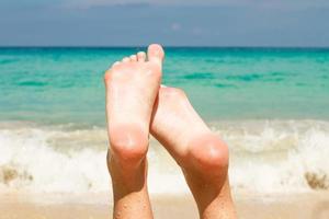 Women's beautiful legs background the turquoise water photo