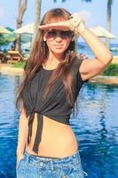 Young beautiful woman walking at exotic resort photo