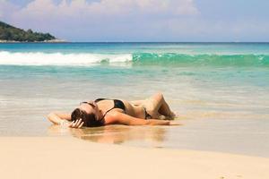 Young woman enjoying summer vacation on tropical white beach photo