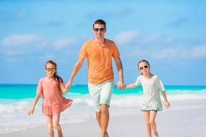 Father and kids enjoying beach summer vacation photo