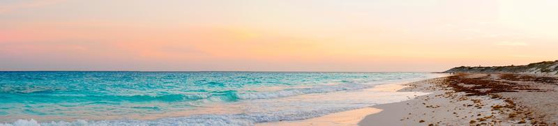 Panorama of amazing beautiful sunset on white sandy beach photo
