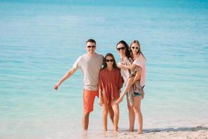 Photo of happy family having fun on the beach. Summer Lifestyle