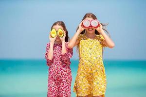 Cute little girls at beach during summer vacation photo