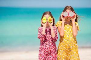 Cute little girls at beach during summer vacation photo