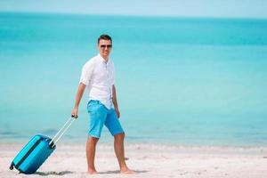 Young man on the beach having fun photo