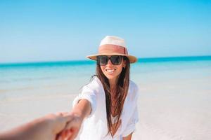 Woman laying on the beach enjoying summer holidays looking at the sea photo