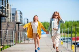 Adorable little girls in port on vacation photo