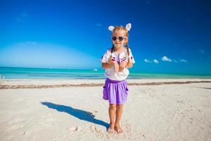 Adorable little girl in easter costume on the exotic beach photo