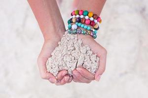 Close-up of sand heart in woman's hands photo