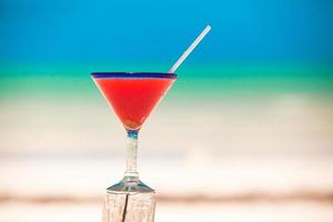 Strawberry margarita on the sandy white beach photo