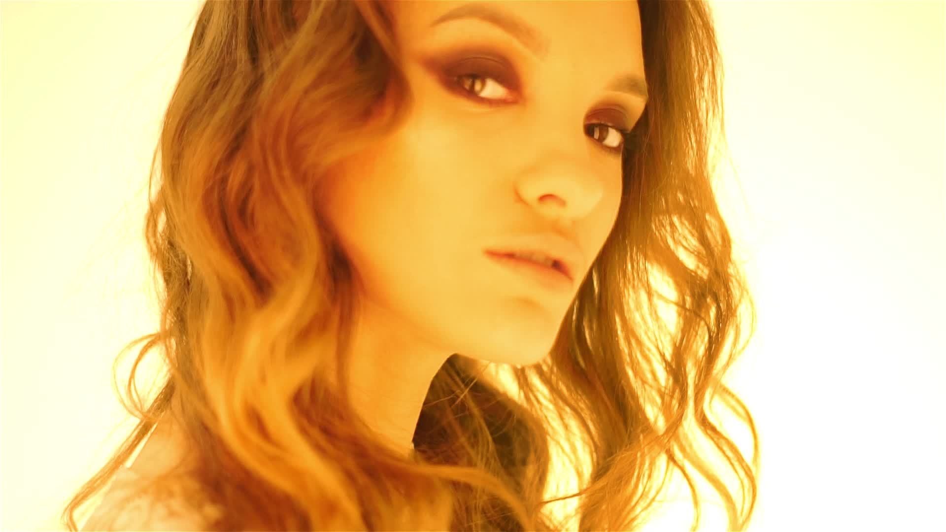 young brown hair girl in warm yellow lights in studio 17756968 Stock