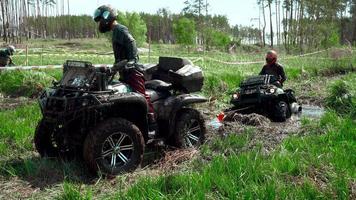 team race through the swamp on an ATV video