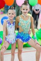 Little gymnasts with medals in rhythmic gymnastics competition photo