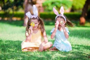 Two little girls wearing bunny ears on Easter eve outdoors photo