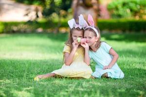 Girls wearing bunny ears on Easter day outdoors. Kids enjoy easter holiday photo