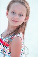 Little girl at beach during summer vacation in the evening photo