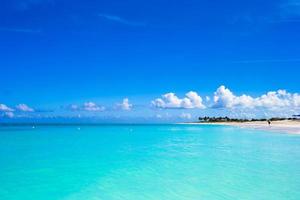 White sandy beach with turquoise water at perfect island photo