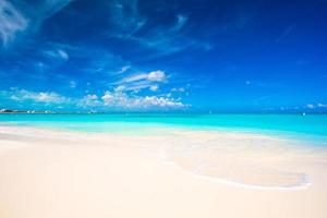 White sandy beach with turquoise water at perfect island photo