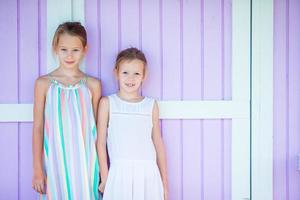 Adorable little sisters at beach during summer vacation photo